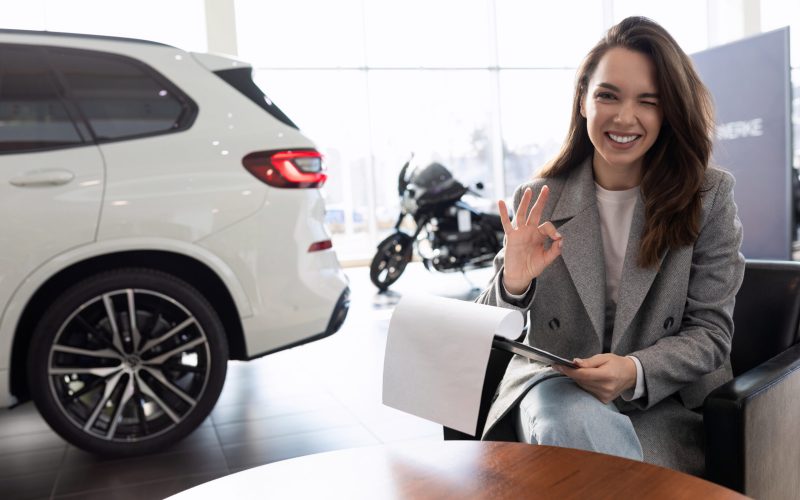 a young woman bought and insured her new car at a car dealership.