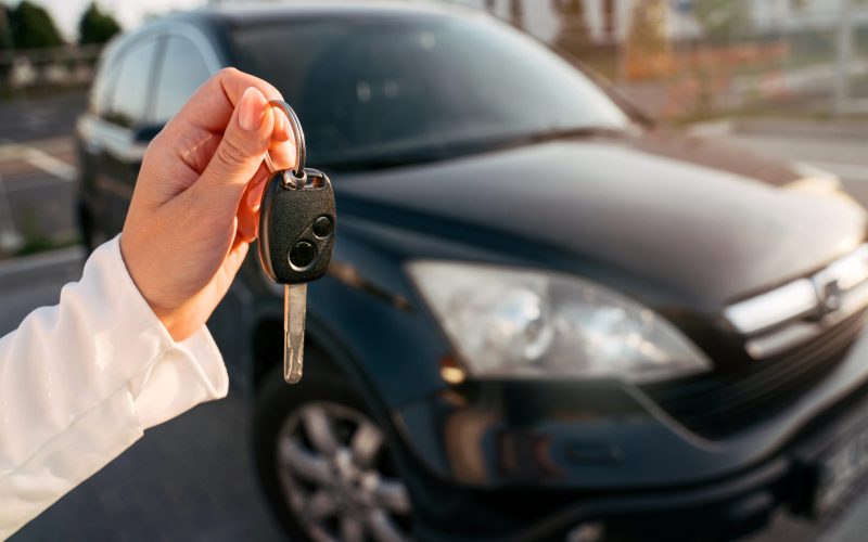 hand-holding-car-keys-selective-focus-woman-buyi-2022-11-19-01-24-17-utc